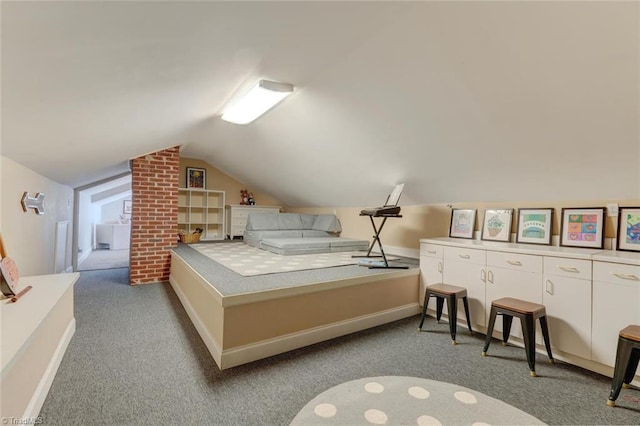 bedroom featuring carpet floors, baseboards, and vaulted ceiling