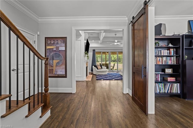 entryway with dark wood-type flooring, coffered ceiling, a barn door, ornamental molding, and beamed ceiling