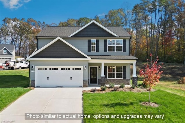 craftsman house featuring driveway, stone siding, an attached garage, covered porch, and a front lawn