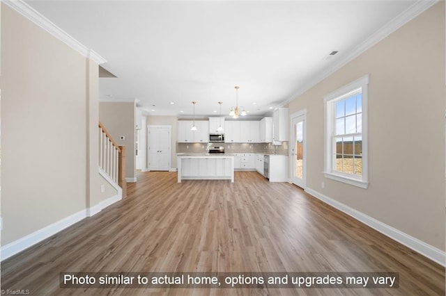 unfurnished living room featuring ornamental molding, stairway, baseboards, and light wood finished floors