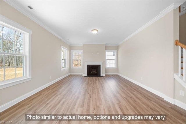 unfurnished living room featuring a fireplace with flush hearth, crown molding, baseboards, and wood finished floors