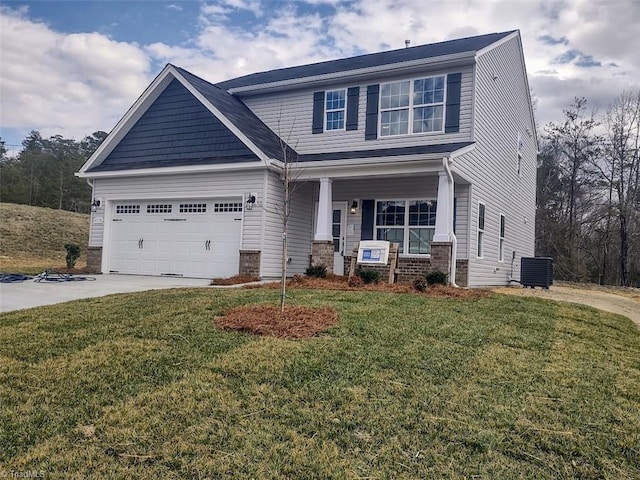 craftsman inspired home featuring a front lawn, cooling unit, and concrete driveway