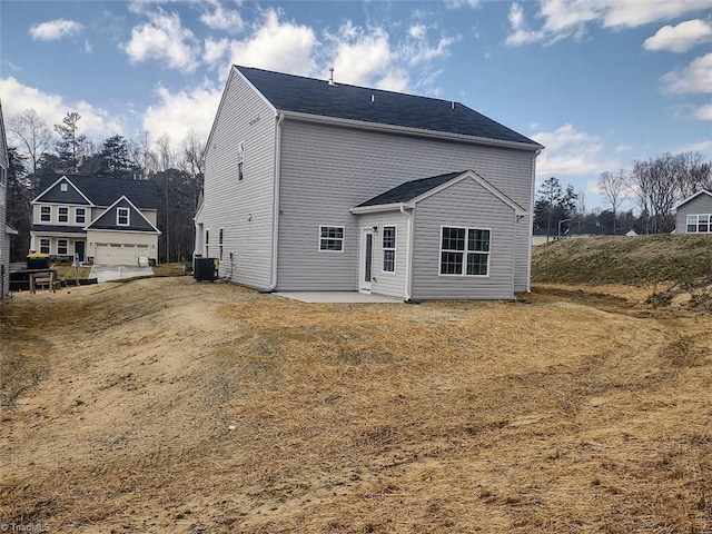 rear view of property featuring cooling unit and a patio