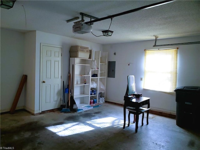 garage with a garage door opener and electric panel