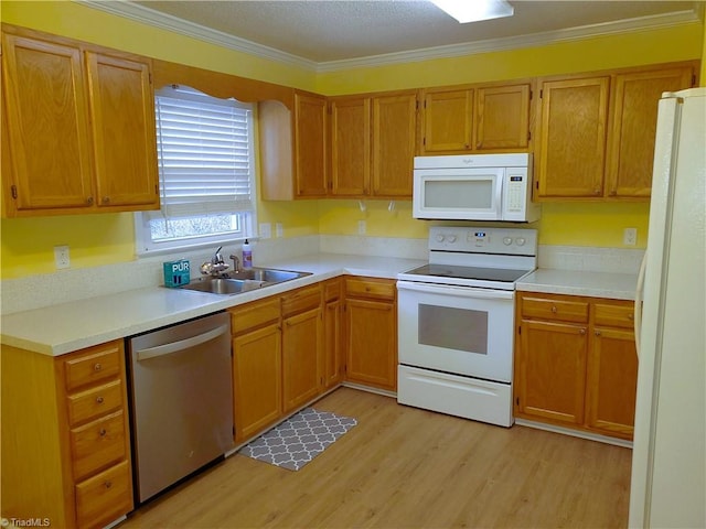 kitchen featuring ornamental molding, sink, white appliances, and light hardwood / wood-style floors