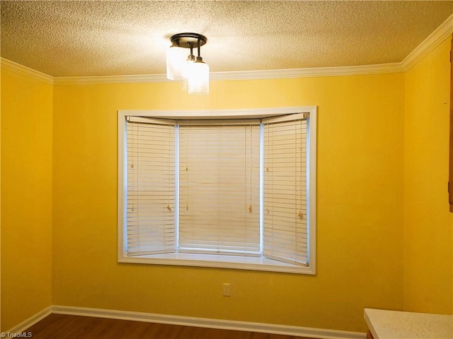 empty room featuring dark hardwood / wood-style flooring, crown molding, and a textured ceiling