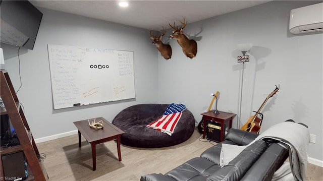 living room with an AC wall unit and light wood-type flooring