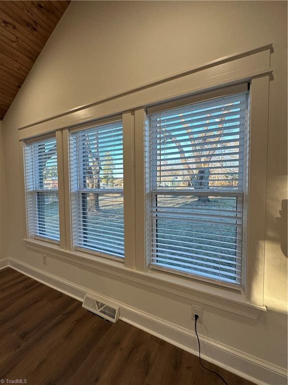 details with baseboards, visible vents, and wood finished floors