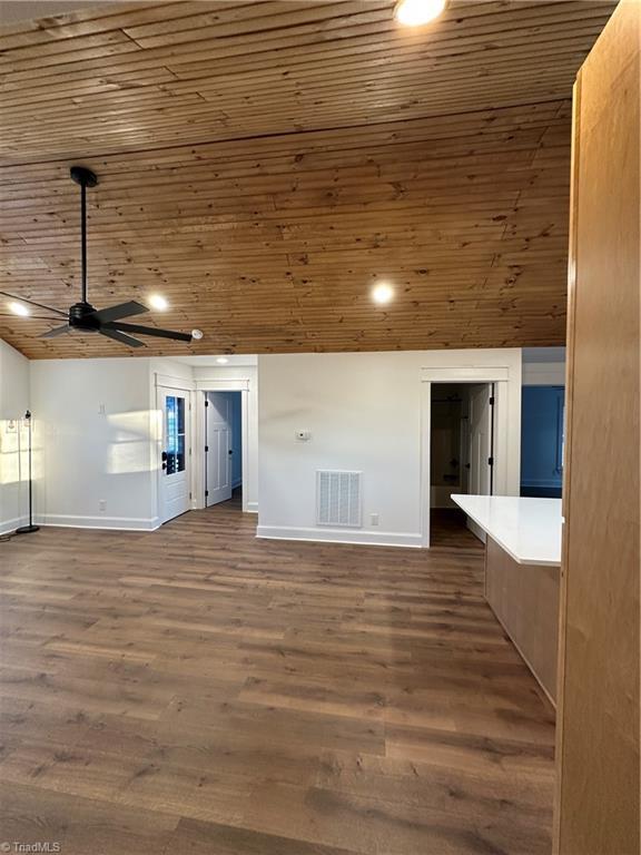 interior space with wooden ceiling, baseboards, visible vents, and dark wood finished floors