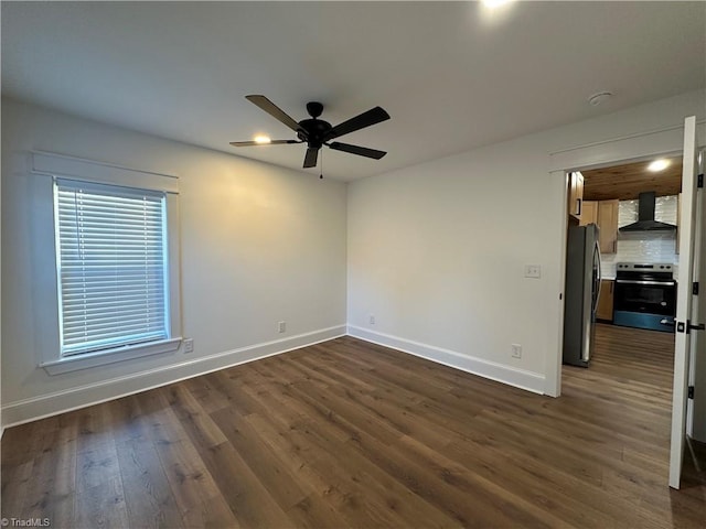 unfurnished room with dark wood-style floors, ceiling fan, and baseboards