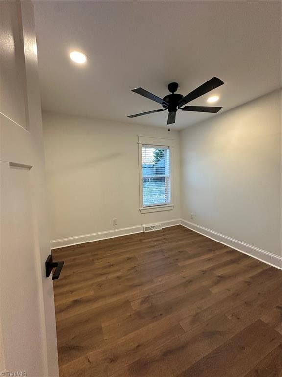 unfurnished room featuring visible vents, baseboards, a ceiling fan, dark wood-style floors, and recessed lighting