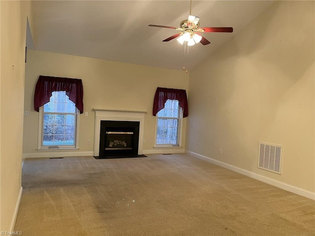 unfurnished living room with carpet, high vaulted ceiling, and ceiling fan