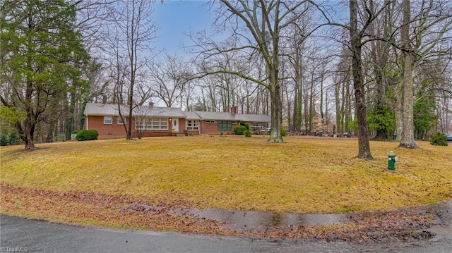 ranch-style home with a front lawn