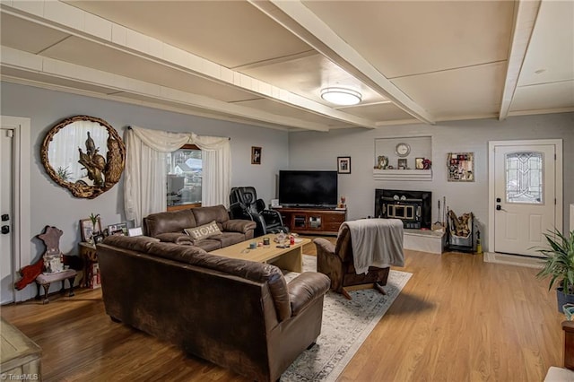 living room featuring beamed ceiling and wood-type flooring