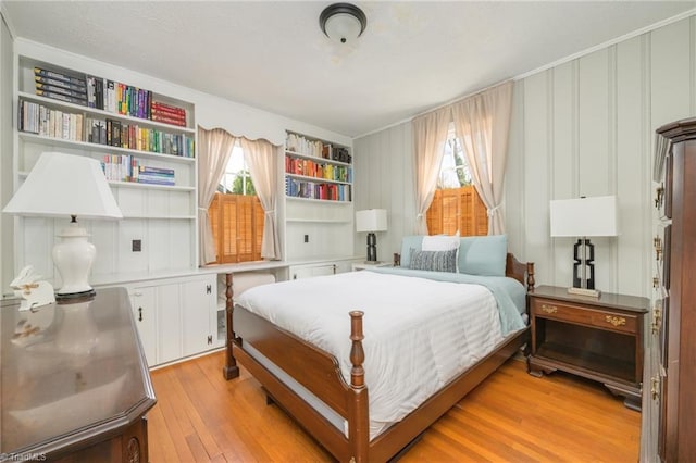 bedroom featuring multiple windows and light wood finished floors