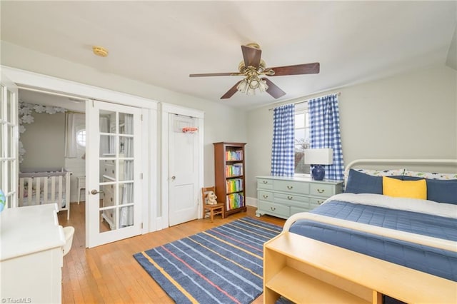 bedroom with hardwood / wood-style flooring, french doors, and ceiling fan