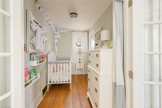 bedroom with wood finished floors and visible vents