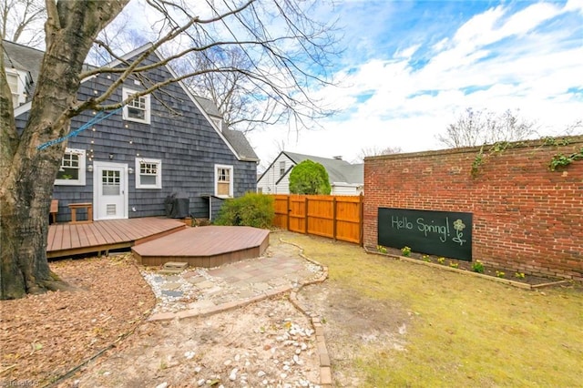 exterior space with a wooden deck and fence