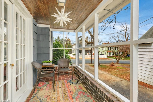 sunroom / solarium featuring wood ceiling