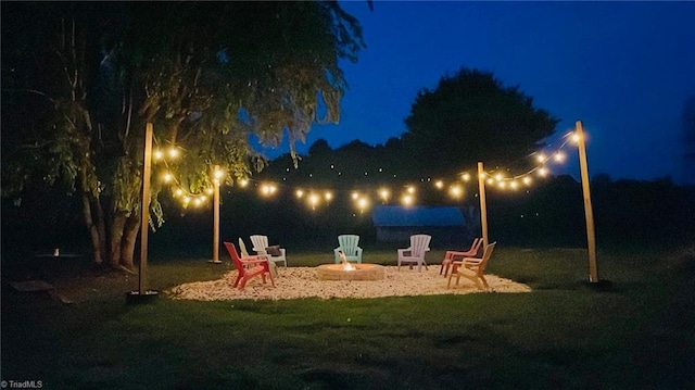 yard at twilight featuring a fire pit