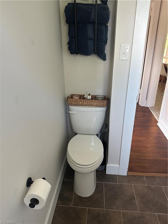 bathroom featuring toilet and baseboards