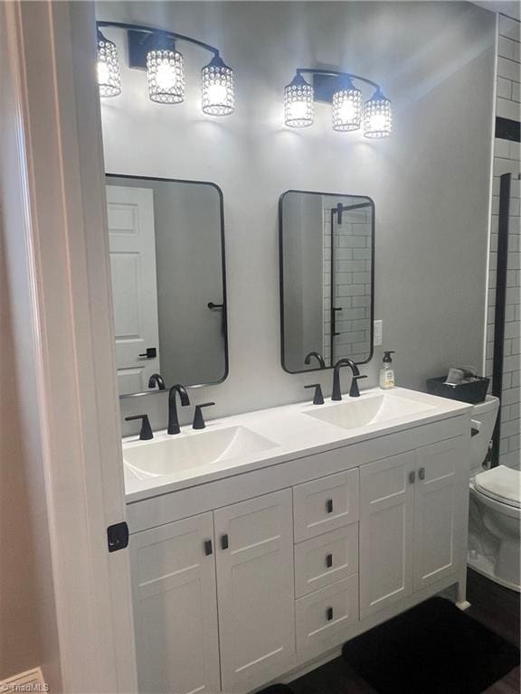 bathroom featuring toilet and vanity