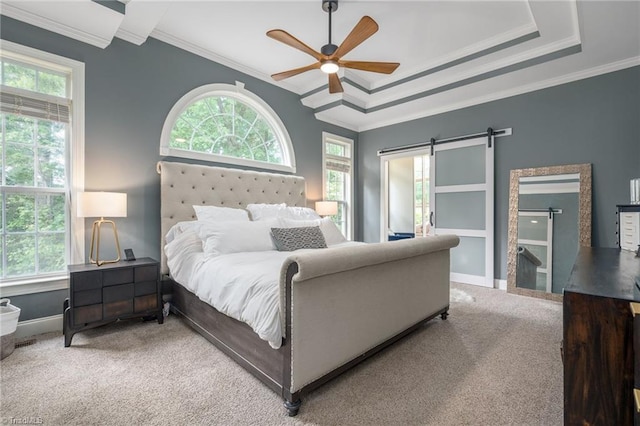 612 Wigeon Dr, Greensboro, NC 27455 - carpeted bedroom with multiple windows, ornamental molding, baseboards, a barn door, and a ceiling fan