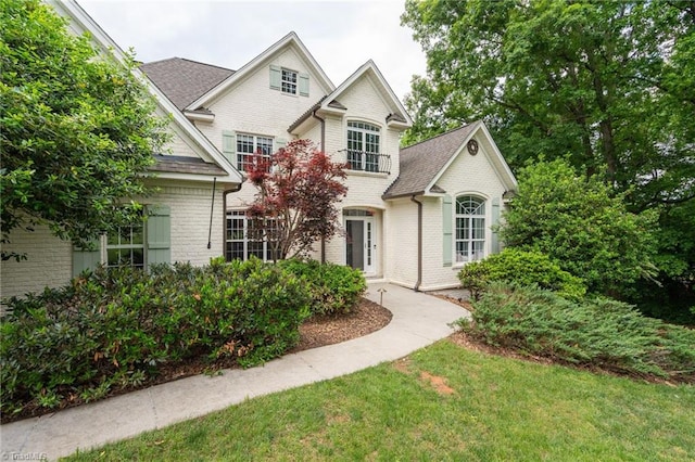 612 Wigeon Dr, Greensboro, NC 27455 - view of front of house with brick siding, roof with shingles, and a front lawn