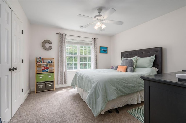 612 Wigeon Dr, Greensboro, NC 27455 - bedroom with light carpet, a ceiling fan, a closet, and baseboards