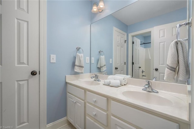 612 Wigeon Dr, Greensboro, NC 27455 - bathroom featuring double vanity and baseboards