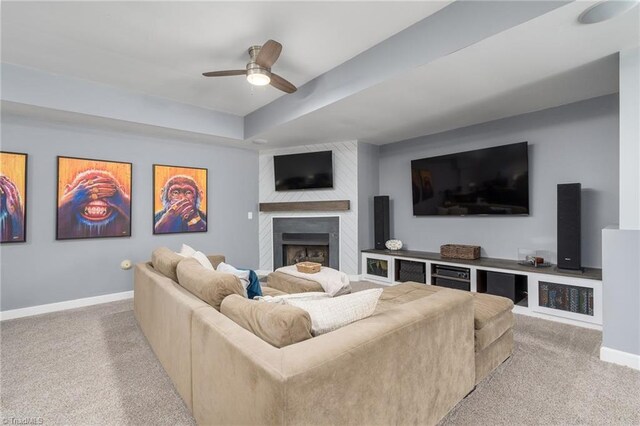 612 Wigeon Dr, Greensboro, NC 27455 - living room featuring carpet, a ceiling fan, a large fireplace, baseboards, and a raised ceiling