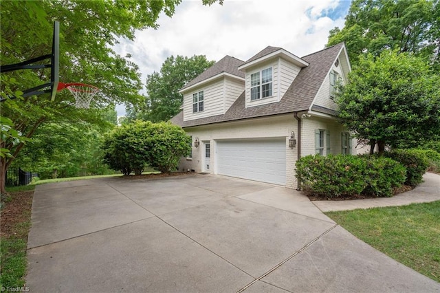 612 Wigeon Dr, Greensboro, NC 27455 - view of home's exterior featuring brick siding, roof with shingles, concrete driveway, and a garage