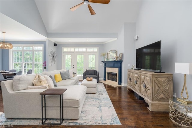 612 Wigeon Dr, Greensboro, NC 27455 - living room with a ceiling fan, dark wood-style floors, a fireplace, a chandelier, and high vaulted ceiling