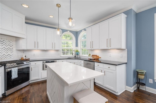 612 Wigeon Dr, Greensboro, NC 27455 - kitchen featuring appliances with stainless steel finishes, crown molding, dark wood-style flooring, white cabinetry, and backsplash