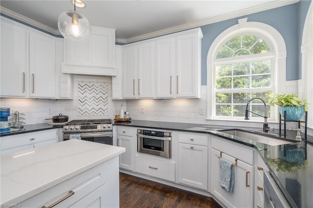 612 Wigeon Dr, Greensboro, NC 27455 - kitchen featuring stainless steel appliances, a sink, crown molding, white cabinetry, and dark stone countertops