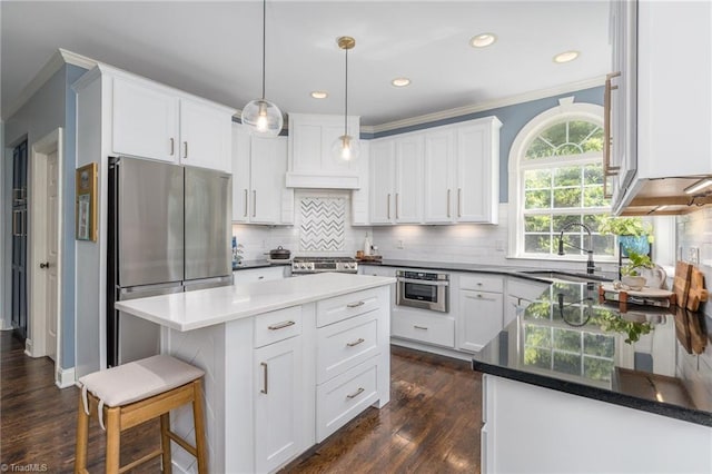 612 Wigeon Dr, Greensboro, NC 27455 - kitchen featuring appliances with stainless steel finishes, crown molding, backsplash, white cabinets, and recessed lighting