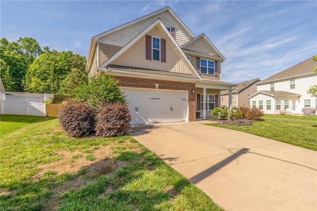4 Harvest Oak Ct, Greensboro, NC 27406 - view of front facade with brick siding, board and batten siding, concrete driveway, and an attached garage