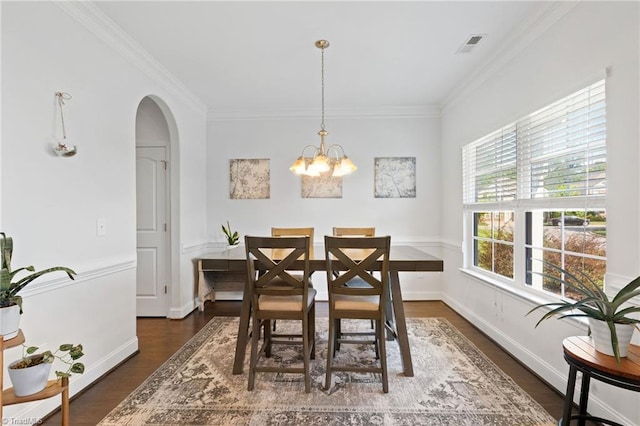 4 Harvest Oak Ct, Greensboro, NC 27406 - dining space with a chandelier, arched walkways, crown molding, wood finished floors, and baseboards