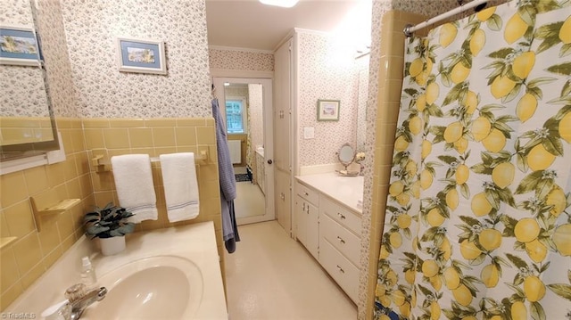 bathroom featuring crown molding, vanity, and walk in shower