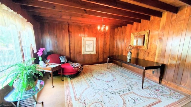 living area featuring wooden walls, beamed ceiling, and a notable chandelier