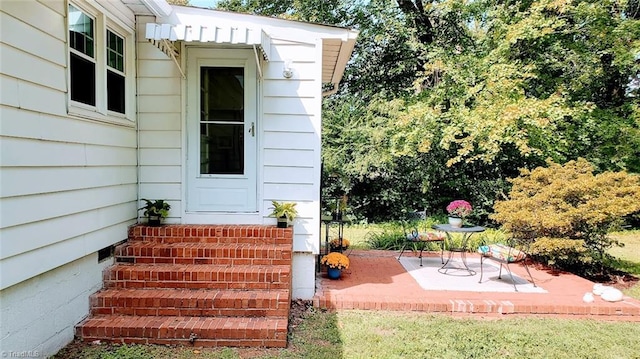 entrance to property with a patio area