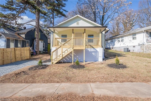 bungalow with a porch and central AC unit