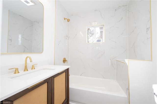 bathroom with tiled shower / bath and vanity