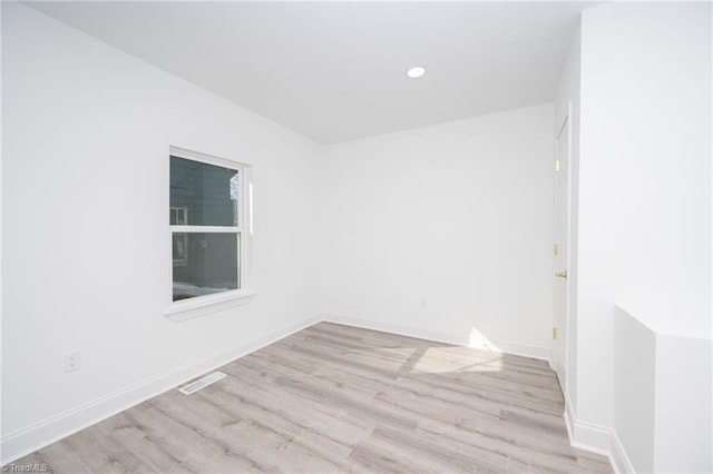 spare room with light hardwood / wood-style floors