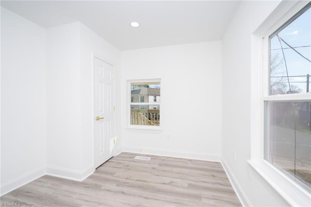 empty room featuring light hardwood / wood-style flooring and plenty of natural light