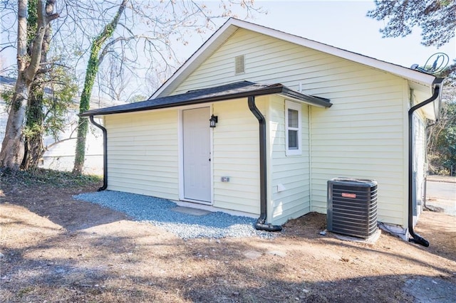 rear view of house featuring cooling unit