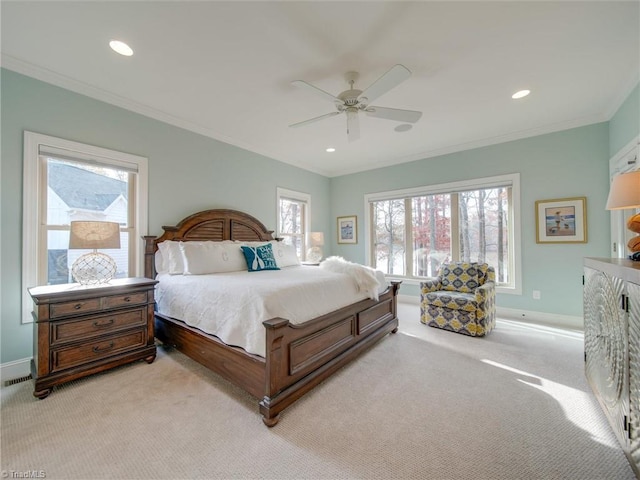 carpeted bedroom with ceiling fan and crown molding