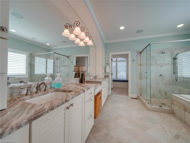 bathroom with plus walk in shower, vanity, and ornamental molding