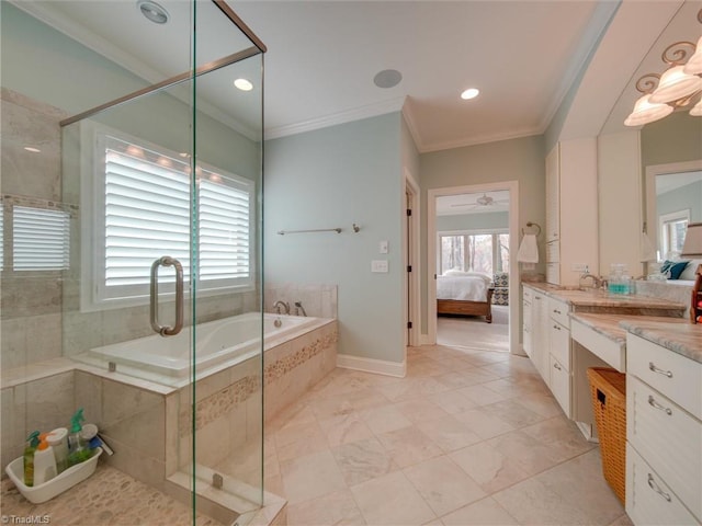 bathroom with a wealth of natural light, vanity, and ornamental molding