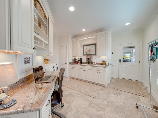 office area with crown molding, washer and clothes dryer, and sink